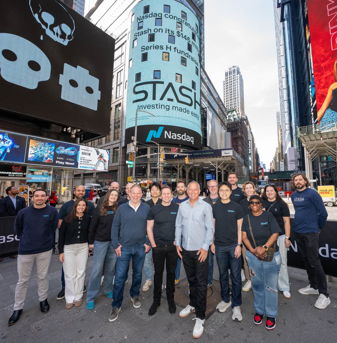 The Stash team in Times Square beneath the Nasdaq tower congratulating Stash on its Series H fundraise