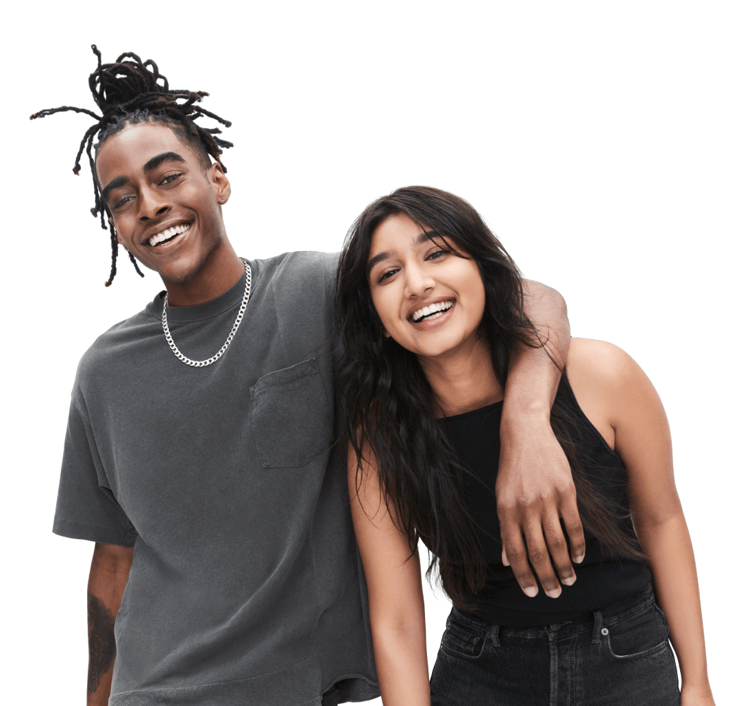 Man smiling with his arm around a women who is also smiling.